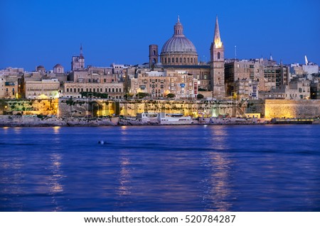 The Valletta skyline with Basilica of Our Lady of Mount Carmel as seen from Sliema at night. Malta