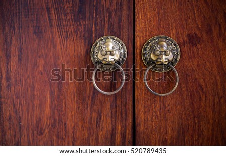 Close-up China style door handle on natural wooden door , selective focus