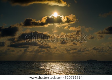 beautiful sunset and  dark sky in a golden sea.