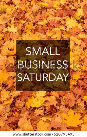 Small business Saturday sign with white text on black square, background with autumn leaves, PART OF SERIES Royalty-Free Stock Photo #520795495