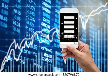 Female hand holding mobile phone showing the chat message before place the order over the Stock market chart,Closeup Stock market exchange data on LED display, business trading and technology concept