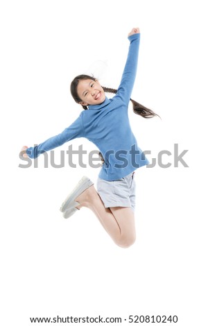 Portrait of happy little Asian child girl jumping isolated on white Royalty-Free Stock Photo #520810240