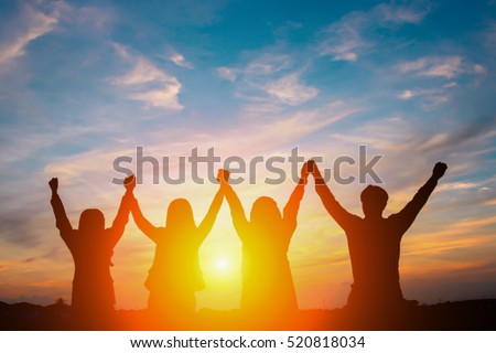 Silhouette of happy business team making high hands in sunset sky background for business teamwork concept