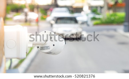 Security equipment and car concept - CCTV camera surveillance on car parking Safety system area control with flare light and copy space