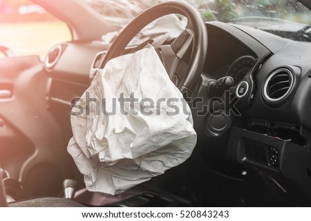 Airbag exploded at a car accident and illuminated Royalty-Free Stock Photo #520843243