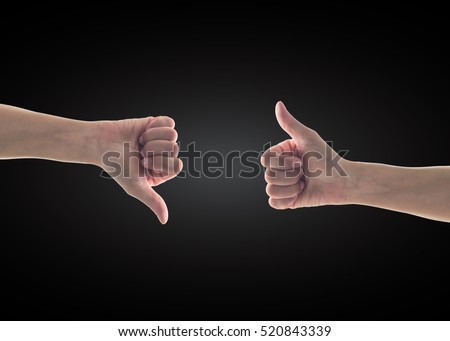 Like - unlike hand with thumb up - down symbolic people gesture isolated on black background with clipping path Royalty-Free Stock Photo #520843339