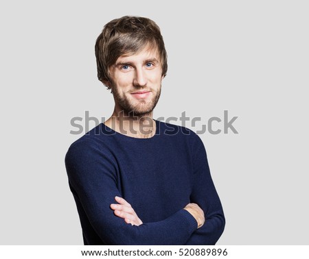 Handsome smiling young man studio portrait