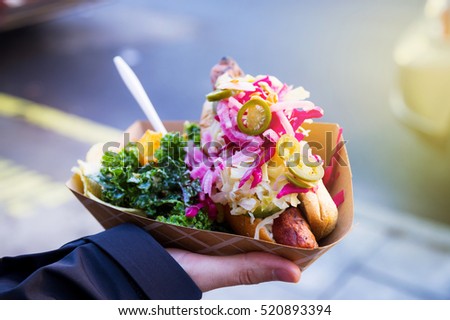 Man with healthy vegan street food from New York  in his right hand Royalty-Free Stock Photo #520893394