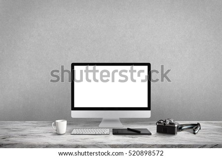 White screen computer in room on gray table and camera film, workplace