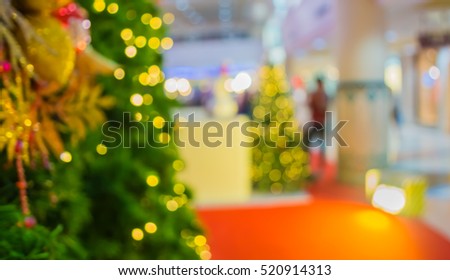 abstract blur image of shopping mall and people on christmas time for background . (vintage tone)