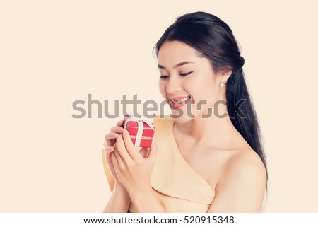 Beautiful happy smiley Asian women holding red gift box, present.