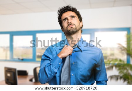 Sweating businessman due to hot climate Royalty-Free Stock Photo #520918720