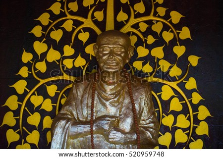 Golden south east asian buddha faces on black background