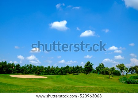 green golf field and blue cloud sky for backdrop background use