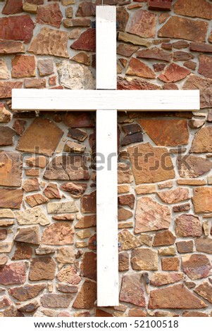 White cross on brown wall