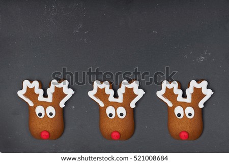 Christmas homemade gingerbread cookie on black slate, moose shaped                            