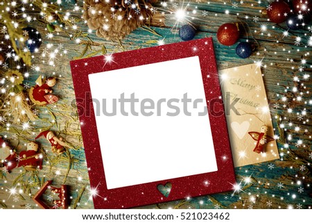Cute Christmas ornaments and stars with empty photo frame on rustic background Royalty-Free Stock Photo #521023462