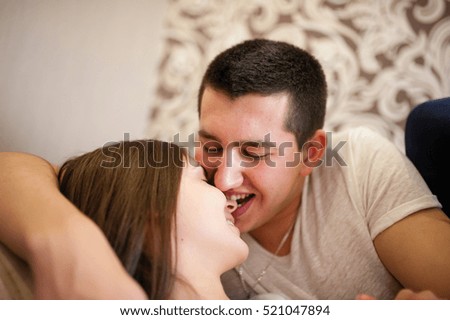 Young couple hugging and kissing on the couch