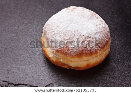Berliner donut on black slate