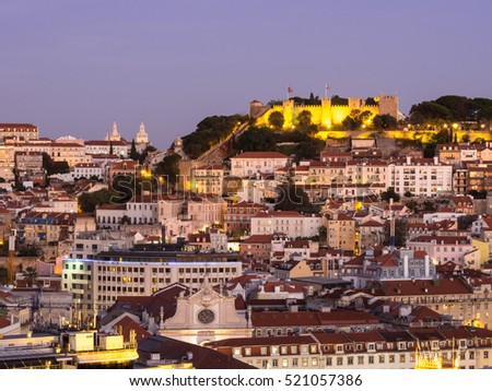 Cityscape of Lisbon, Portugal, with the Sao Jorge Castle seen from Miradouro Sao Pedro de Alcantara at night.