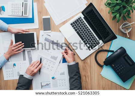 Business team working at office desk and analyzing financial reports, finance and accounting concept, top view Royalty-Free Stock Photo #521063305