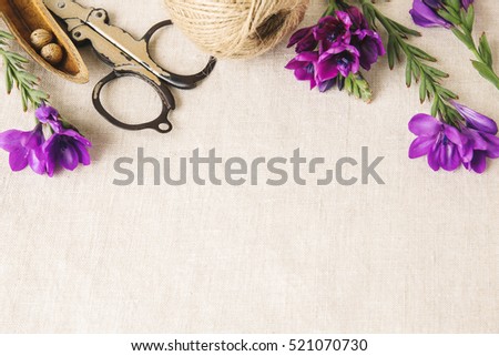Purple flowers craft twine work on linen toning copy space background