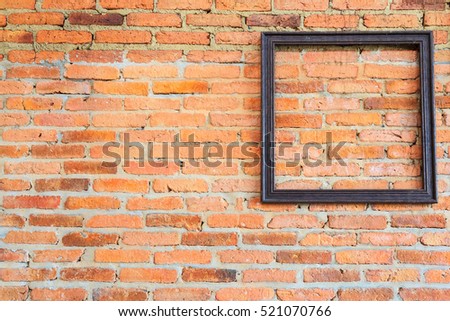 Brick wall texture in vintage background with picture frame.