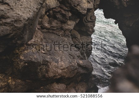 Deep blue sea waves splashin volcanic rocks, Catania, Sicily coast