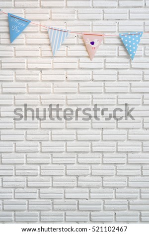 White brick wall decorated by colorful cartoon flag for children baby shower party or children bedroom