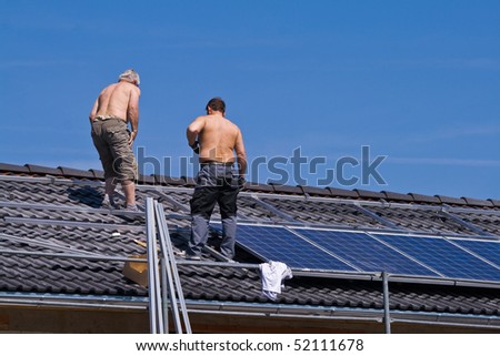 Installing solar modules on a roof Royalty-Free Stock Photo #52111678