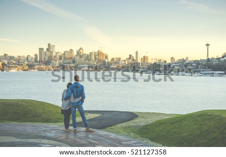 a couple hug and looking Seattle city landscape with sunset ,Seattle,Washington,USA..