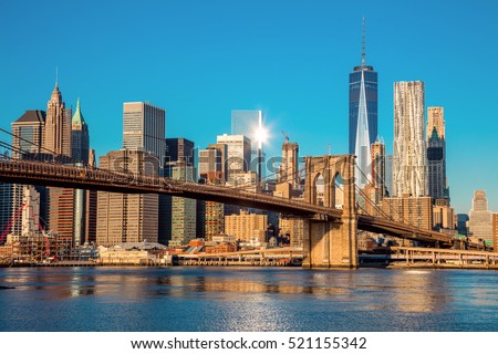 Famous Skyline of downtown New York, Brooklin Bridge and  Manhattan at the early morning sun light , New York City, USA Royalty-Free Stock Photo #521155342