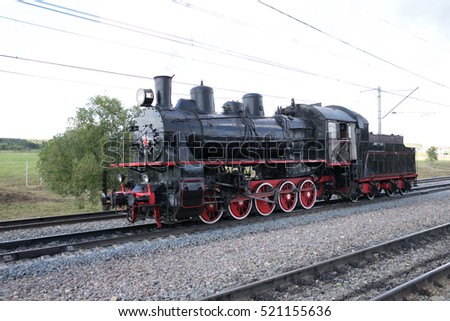 Russian steam locomotive on the background of a stormy sky