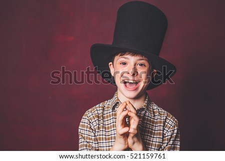 portrait, close up, children's emotions. Teen with a hat cylinder