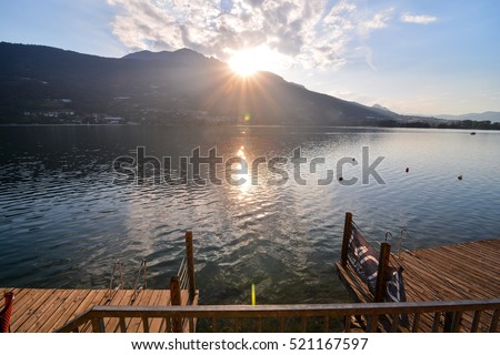 Photo Lake Lago di Caldonazzo on the Background of Dolomites in Italy