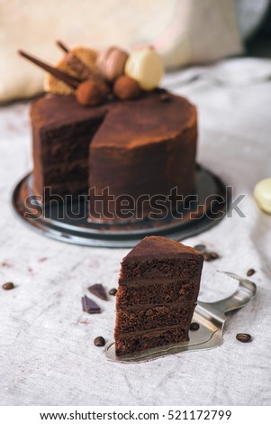 Slice of a homemade ultimate chocolate cake on a vintage cake server 