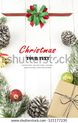 Christmas background with decorations and gift box on white wooden board. Christmas border with decoration ornaments. Top view of christmas border.Traditional christmas decoration with copy space. Royalty-Free Stock Photo #521177230