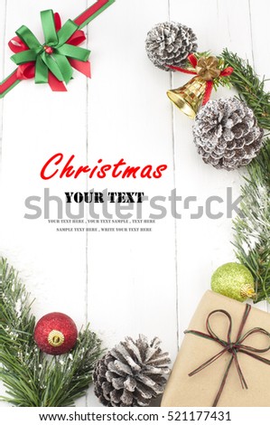 Christmas background with decorations and gift box on white wooden board. Christmas border with decoration ornaments. Top view of christmas border.Traditional christmas decoration with copy space. Royalty-Free Stock Photo #521177431