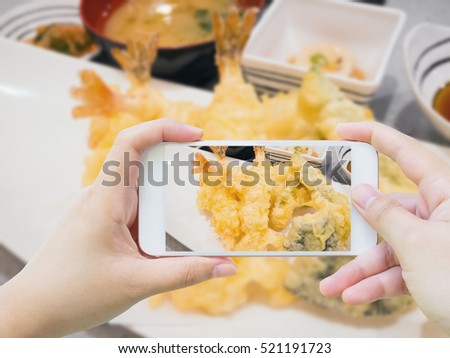 Taking photo of prawns tempura on white plate, Japanese cuisine