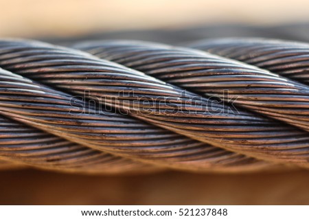 Industrial twisted metal tow cable for heavy vehicles or machinery Royalty-Free Stock Photo #521237848