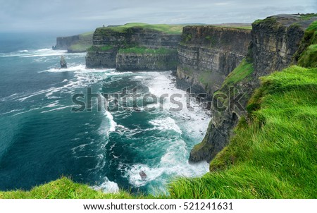 Spectacular view of famous Cliffs of Moher and wild Atlantic Ocean, County Clare, Ireland. Royalty-Free Stock Photo #521241631