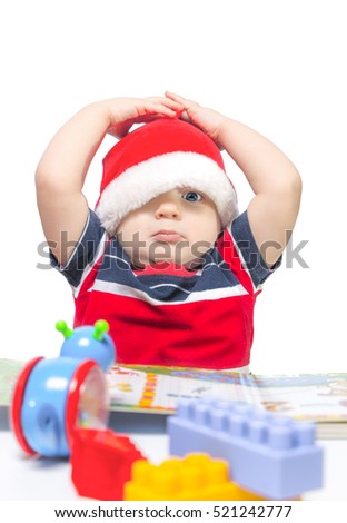 little boy 1 year in hat Santa Claus draws red pencil, smiling to his mother. White background. family happiness