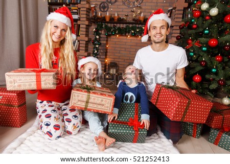 Beautiful family with Christmas gifts