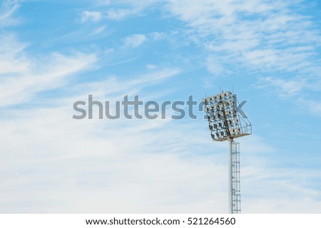 Stadium floodlight tower with blue sky background