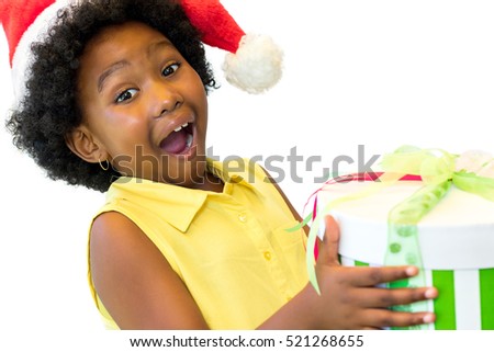 Close up portrait of exited little african kid holding if christmas gift.Isolated on white background.