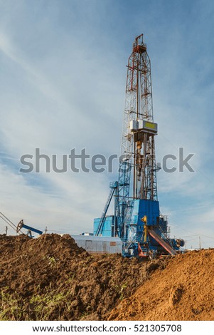 oil drilling rig land onshore blue sky
