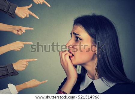 Anxious woman judged by different hands. Concept of accusation of guilty girl. Negative human emotions face expression feeling   Royalty-Free Stock Photo #521314966