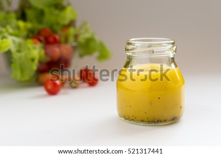 homemade basic salad dressing made with olive oil lemon juice honey salt and black peppers.
 Royalty-Free Stock Photo #521317441