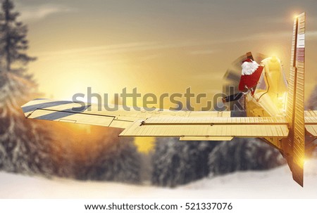 Santa claus in yellow small plane and sky 