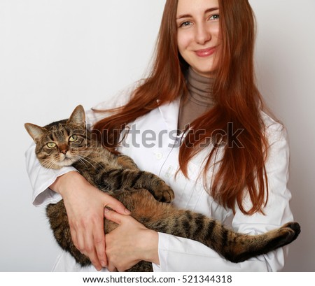 Vet doctor smiling and  holding cute cat closeup